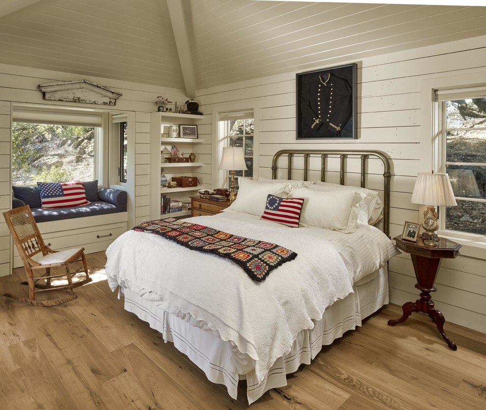 Design ideas for a rustic bedroom in San Francisco with white walls, light hardwood flooring and beige floors.