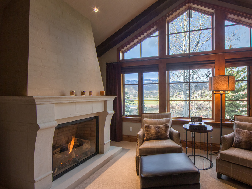 Photo of a large traditional master bedroom in Denver with white walls, concrete flooring, a standard fireplace, a brick fireplace surround, white floors and exposed beams.
