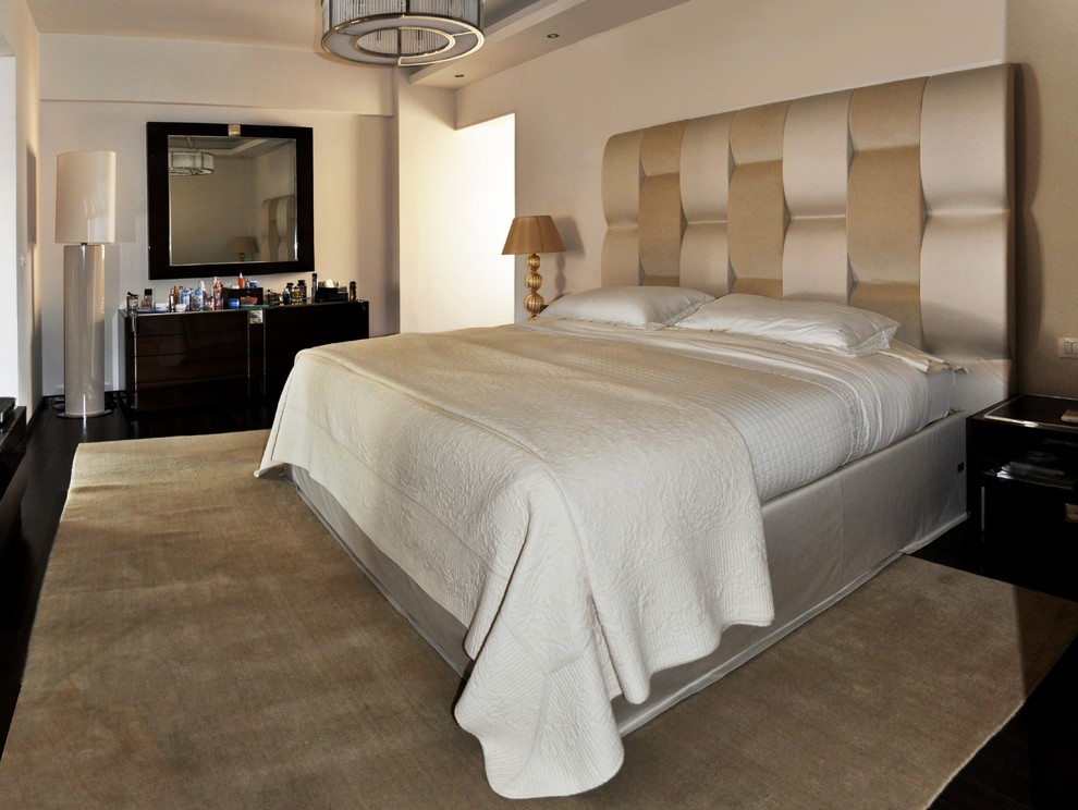 Foto de dormitorio principal actual de tamaño medio con paredes beige, suelo de contrachapado y suelo marrón