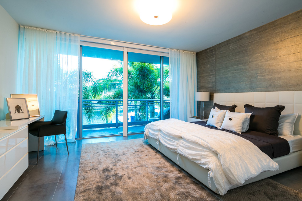 Inspiration for a modern master bedroom in Miami with grey walls and porcelain flooring.