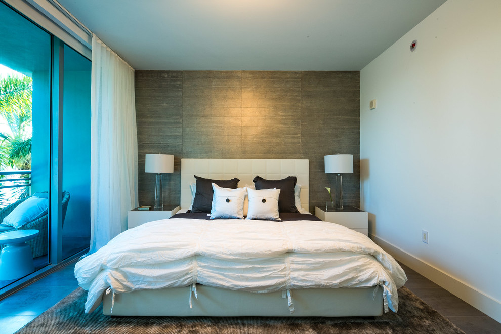 Photo of a contemporary master and grey and brown bedroom in Miami with grey walls, porcelain flooring and a feature wall.