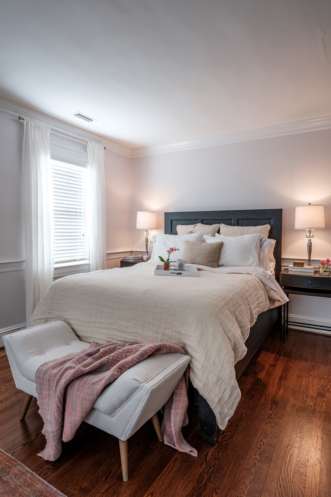 Small eclectic master bedroom in Raleigh with grey walls, medium hardwood flooring and brown floors.