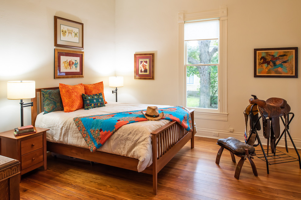 Photo of an eclectic guest bedroom in Austin with white walls.