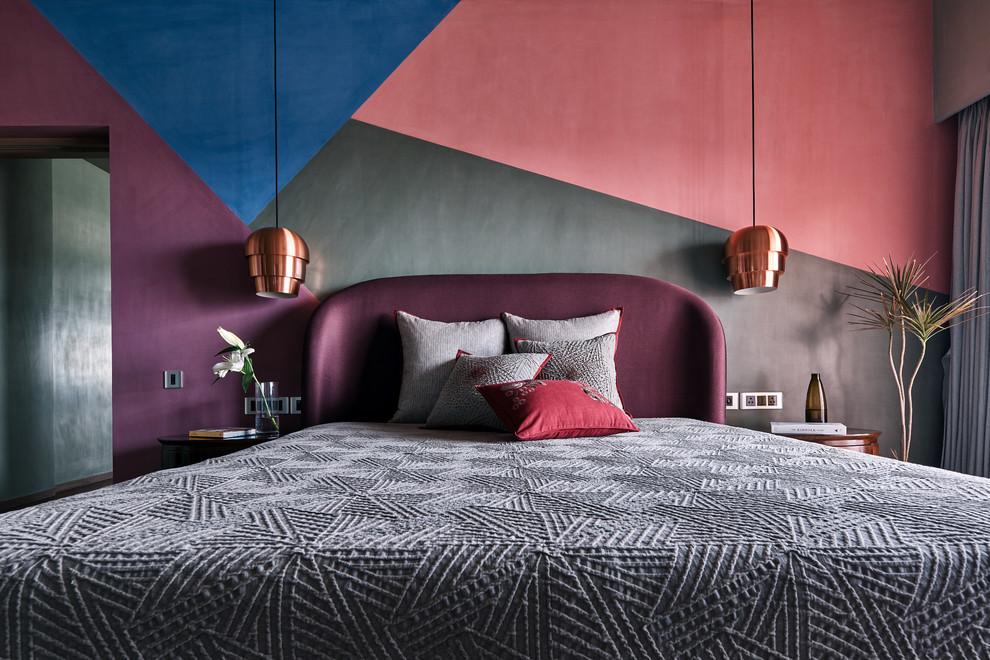 This is an example of a contemporary grey and pink bedroom in Bengaluru with multi-coloured walls and a feature wall.