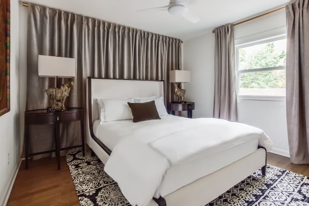 Bedroom - zen guest medium tone wood floor and brown floor bedroom idea in Atlanta with white walls and no fireplace