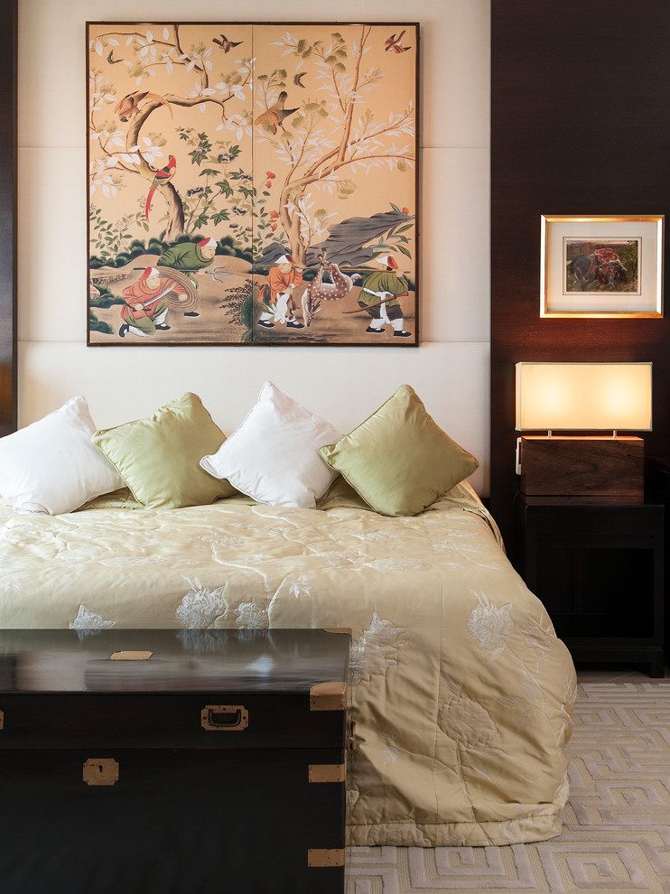 This is an example of a world-inspired bedroom in Hong Kong with beige walls and carpet.