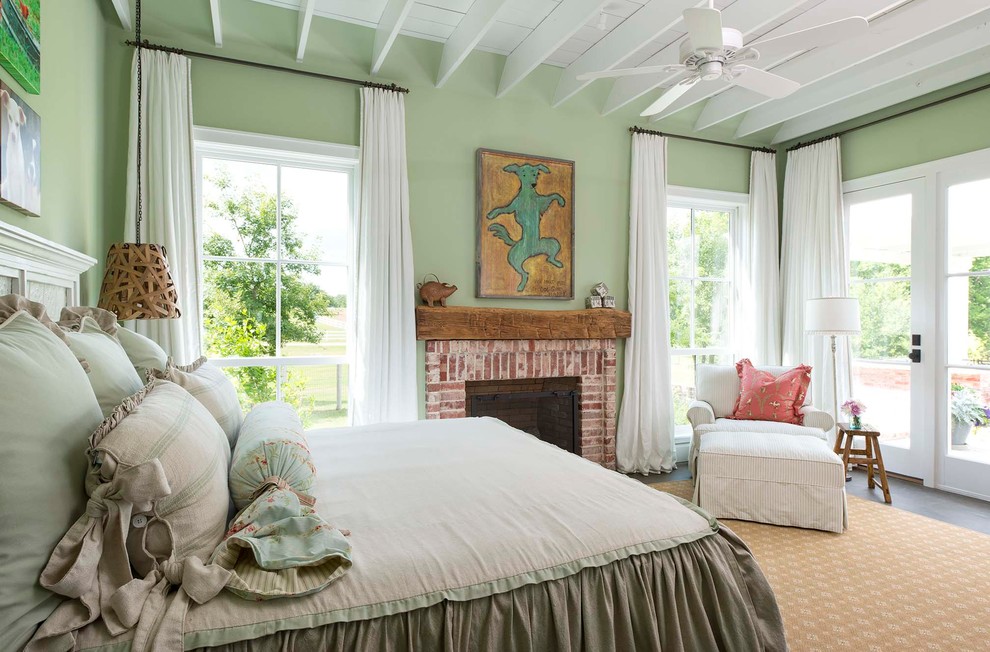 Country bedroom photo in Dallas with green walls, a standard fireplace and a brick fireplace