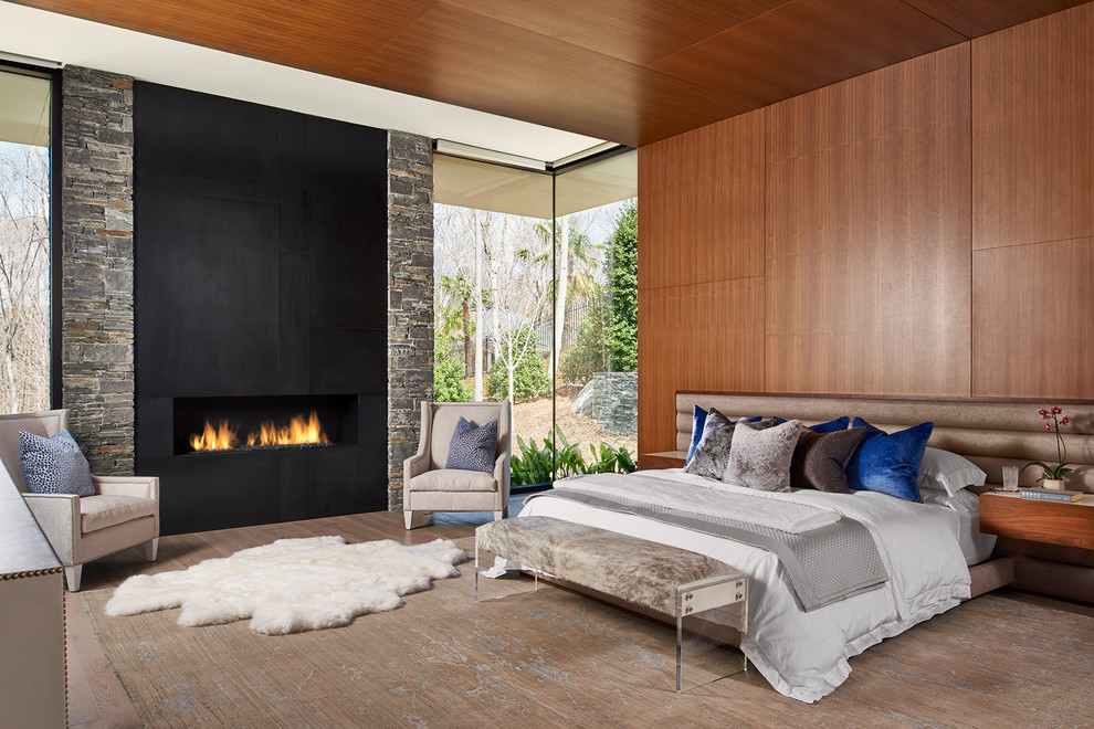 Design ideas for a large contemporary master bedroom in Atlanta with a metal fireplace surround, brown walls and a ribbon fireplace.