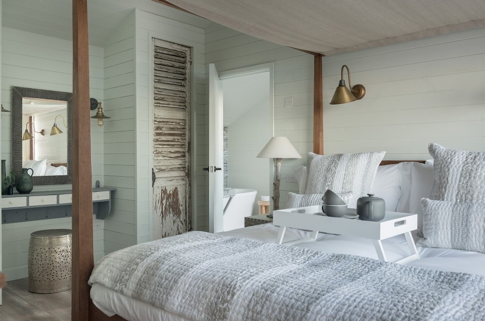 Example of a mid-sized beach style gray floor bedroom design in Cornwall with white walls
