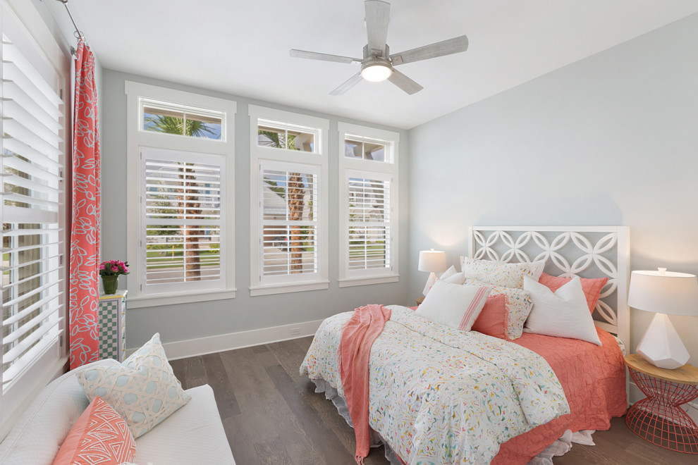 Inspiration for a beach style bedroom in Jacksonville with grey walls, dark hardwood flooring and brown floors.