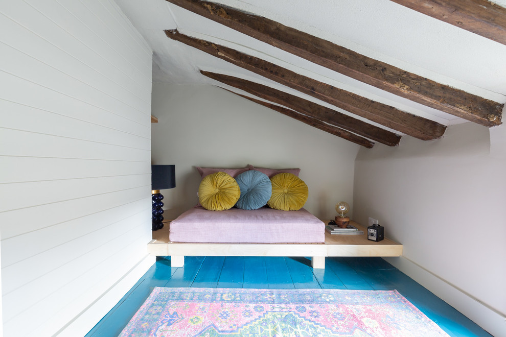 Kleines Eklektisches Gästezimmer ohne Kamin mit beiger Wandfarbe, gebeiztem Holzboden und blauem Boden in Sonstige