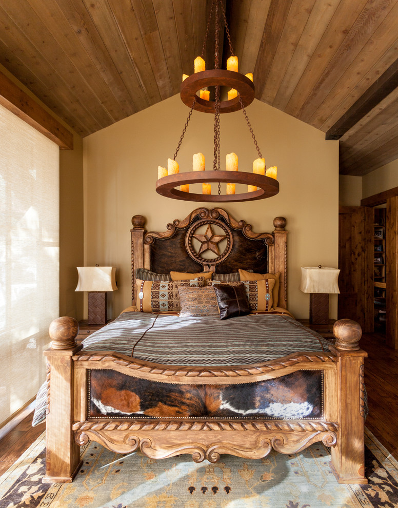 This is an example of a rustic bedroom in Sacramento with white walls, medium hardwood flooring and no fireplace.
