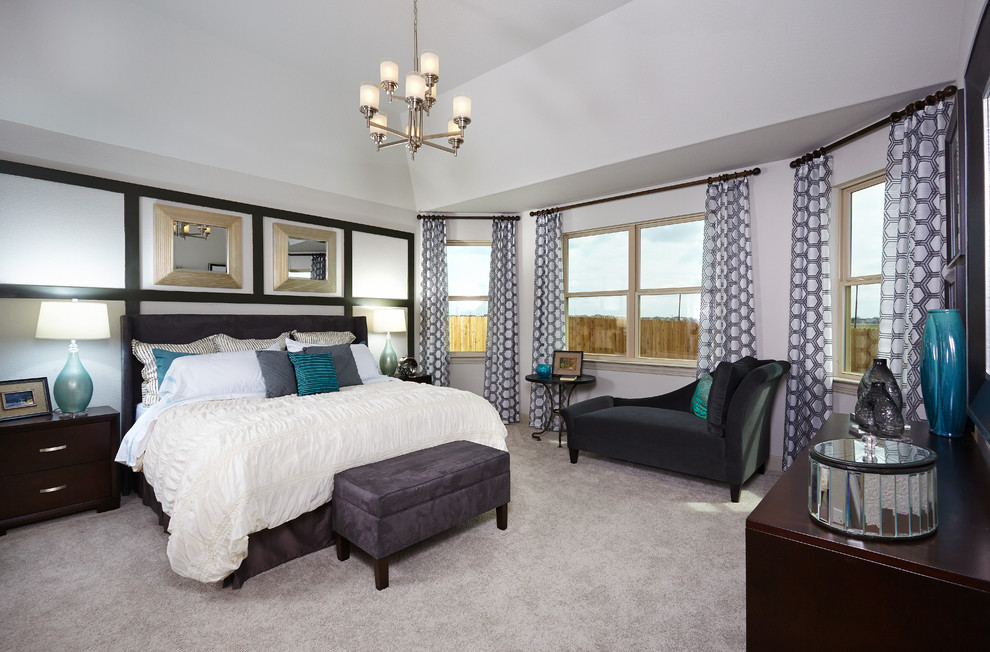 Large traditional master bedroom in Austin with grey walls and carpet.