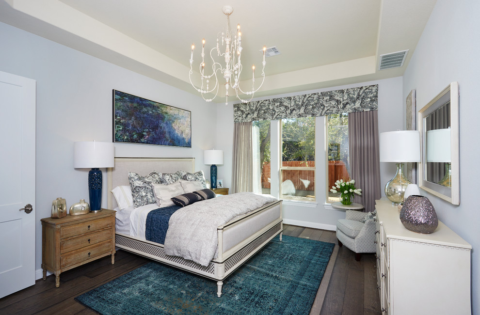 Design ideas for a large farmhouse master bedroom in Austin with beige walls, dark hardwood flooring and brown floors.