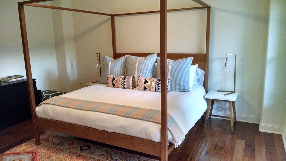 Large bohemian master bedroom in Austin with white walls and medium hardwood flooring.