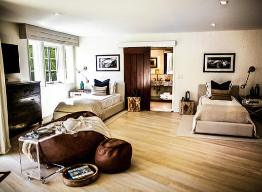 Design ideas for a medium sized traditional bedroom in New York with beige walls and light hardwood flooring.