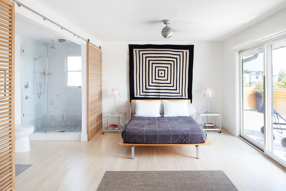 Inspiration for a scandinavian master bedroom in Philadelphia with white walls and light hardwood flooring.