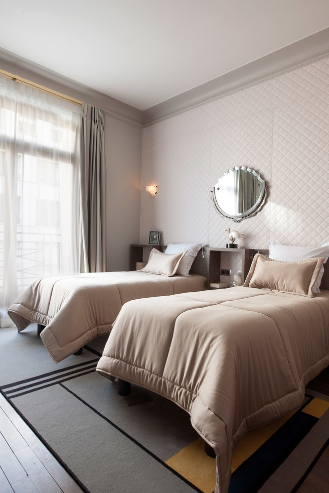 Example of a mid-sized transitional guest bedroom design in London with white walls