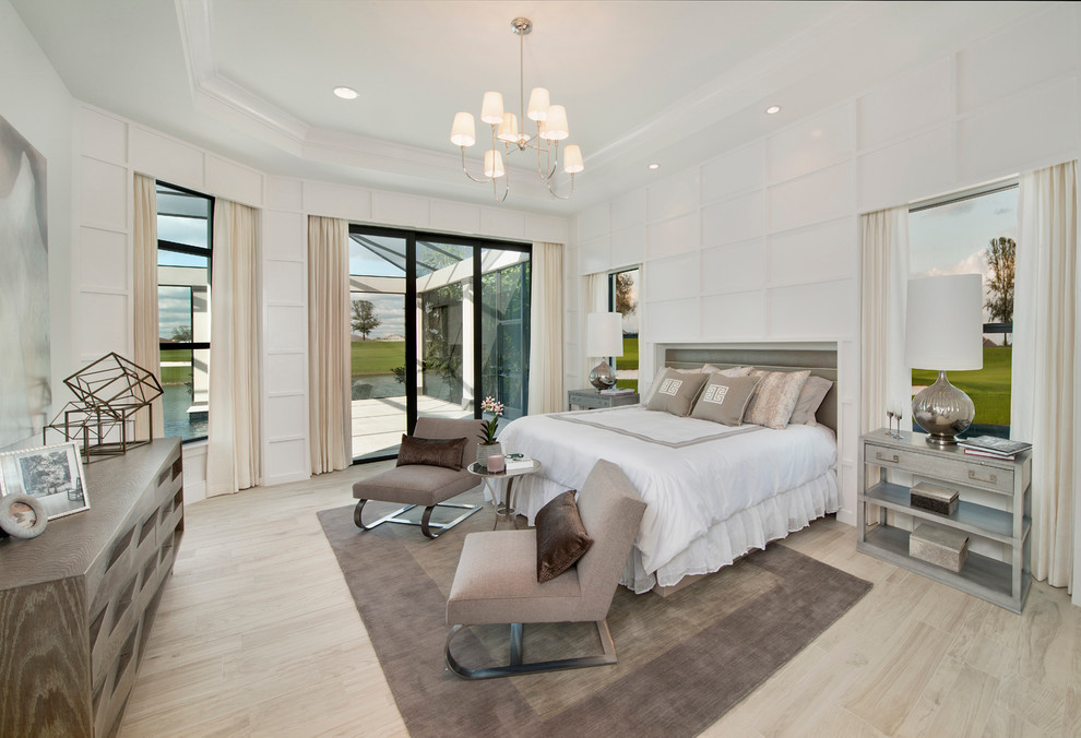 Inspiration for a transitional light wood floor bedroom remodel in Miami with white walls