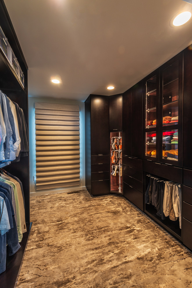 Medium sized contemporary dressing room for men in Other with flat-panel cabinets, dark wood cabinets, carpet and multi-coloured floors.