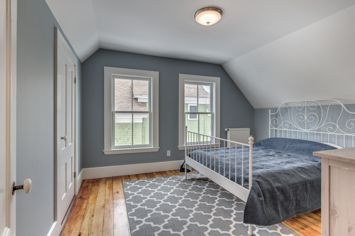 Bedroom - mid-sized victorian guest light wood floor bedroom idea in Boston with blue walls