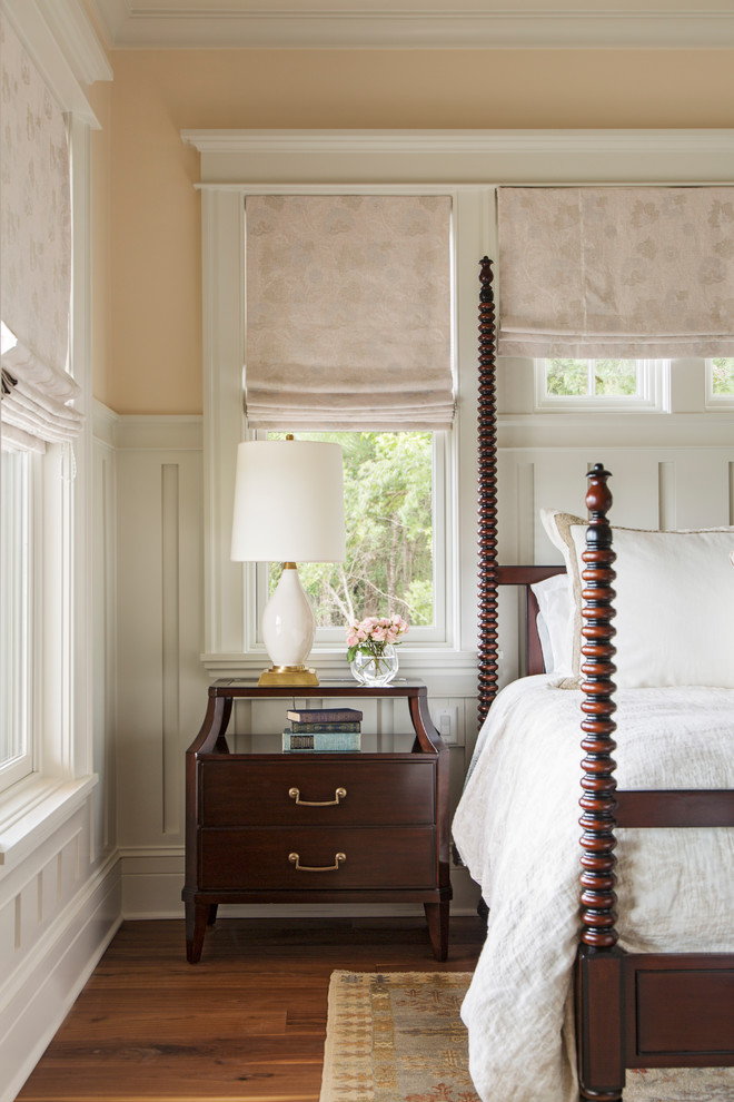 Inspiration for a large timeless master medium tone wood floor bedroom remodel in Charleston with pink walls