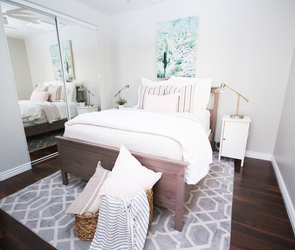 This is an example of a medium sized classic guest bedroom in Phoenix with grey walls, laminate floors and brown floors.