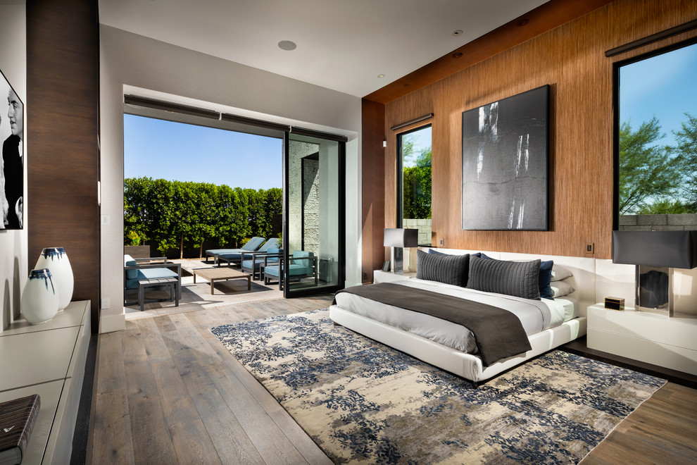 This is an example of a large contemporary master bedroom in Phoenix with dark hardwood flooring, brown floors and brown walls.