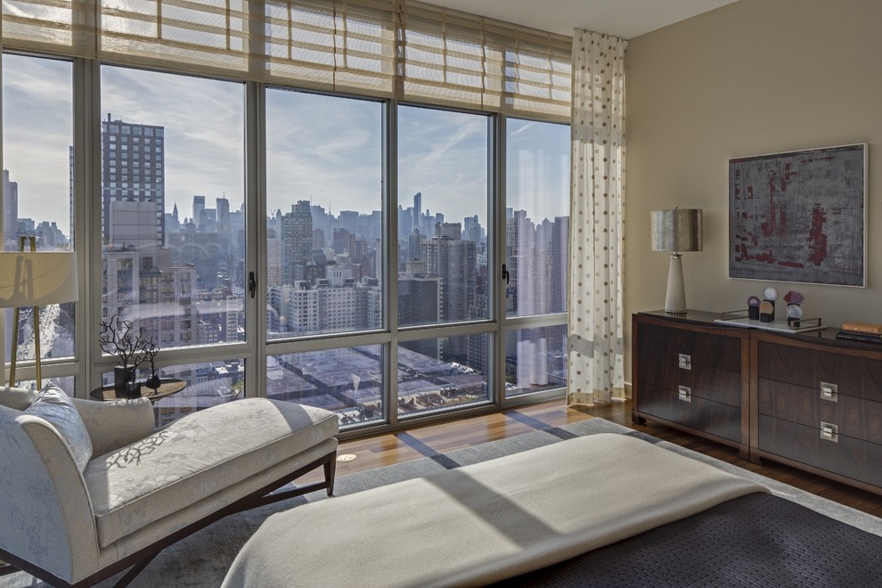 Medium sized classic guest bedroom in New York with beige walls and dark hardwood flooring.