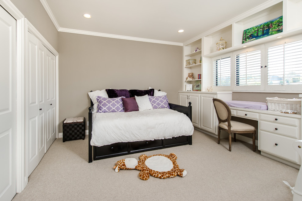 Photo of a small traditional master bedroom in Los Angeles with beige walls and carpet.