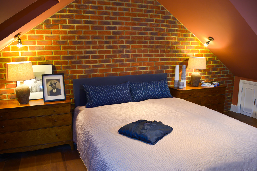 Medium sized traditional mezzanine bedroom in London with orange walls and medium hardwood flooring.