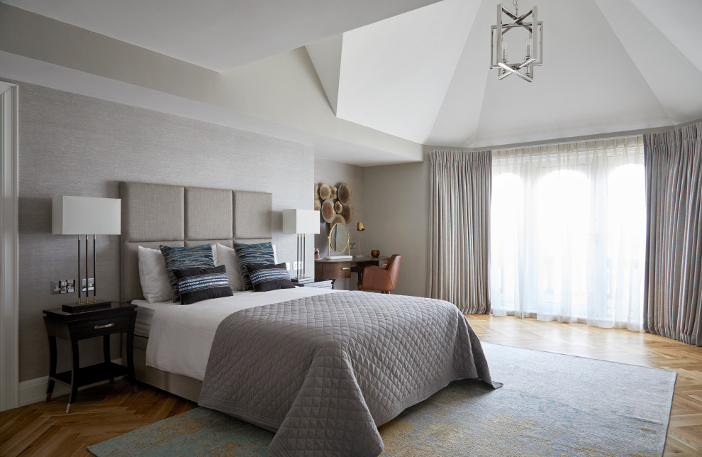 Großes Modernes Hauptschlafzimmer mit grauer Wandfarbe, braunem Holzboden, gewölbter Decke und Tapetenwänden in London