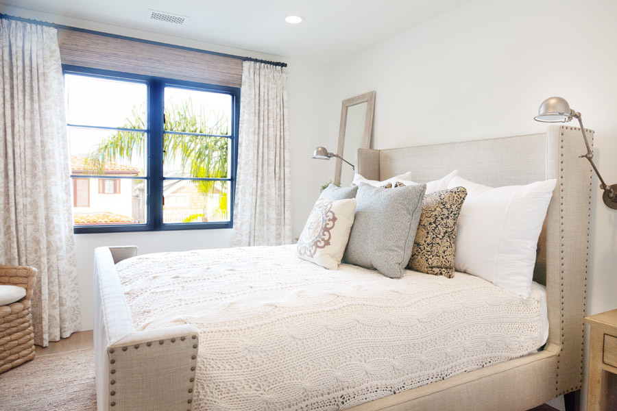 Coastal guest bedroom in Orange County with white walls.