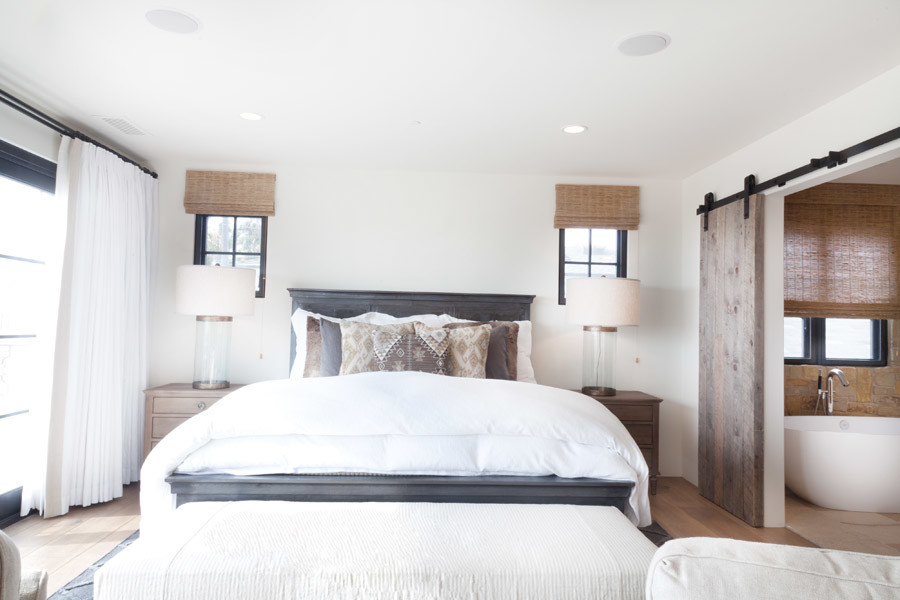 Beach style guest bedroom photo in Orange County with white walls