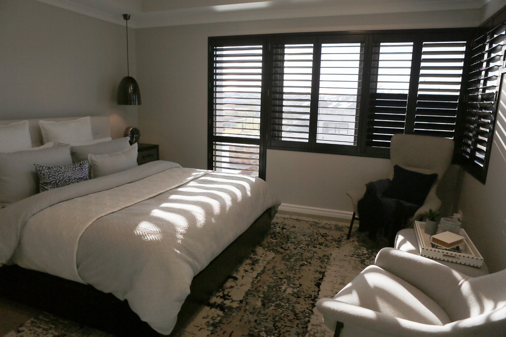 Photo of a medium sized traditional master bedroom in Perth with grey walls and concrete flooring.