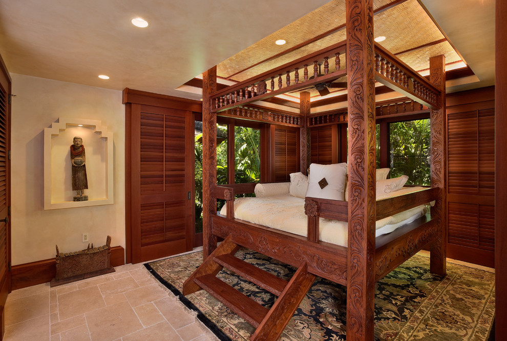 Large world-inspired bedroom in Hawaii with beige walls, travertine flooring, no fireplace and beige floors.