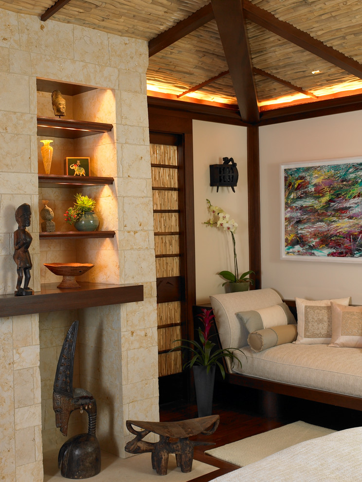 Diseño de dormitorio principal de estilo zen con todas las chimeneas y marco de chimenea de piedra