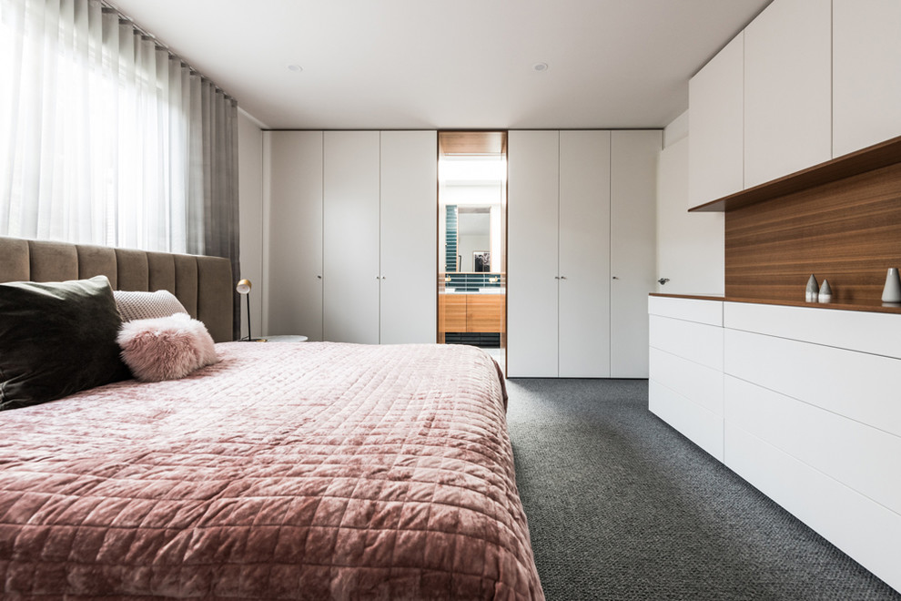 На фото: хозяйская спальня среднего размера в современном стиле с белыми стенами, ковровым покрытием и серым полом без камина