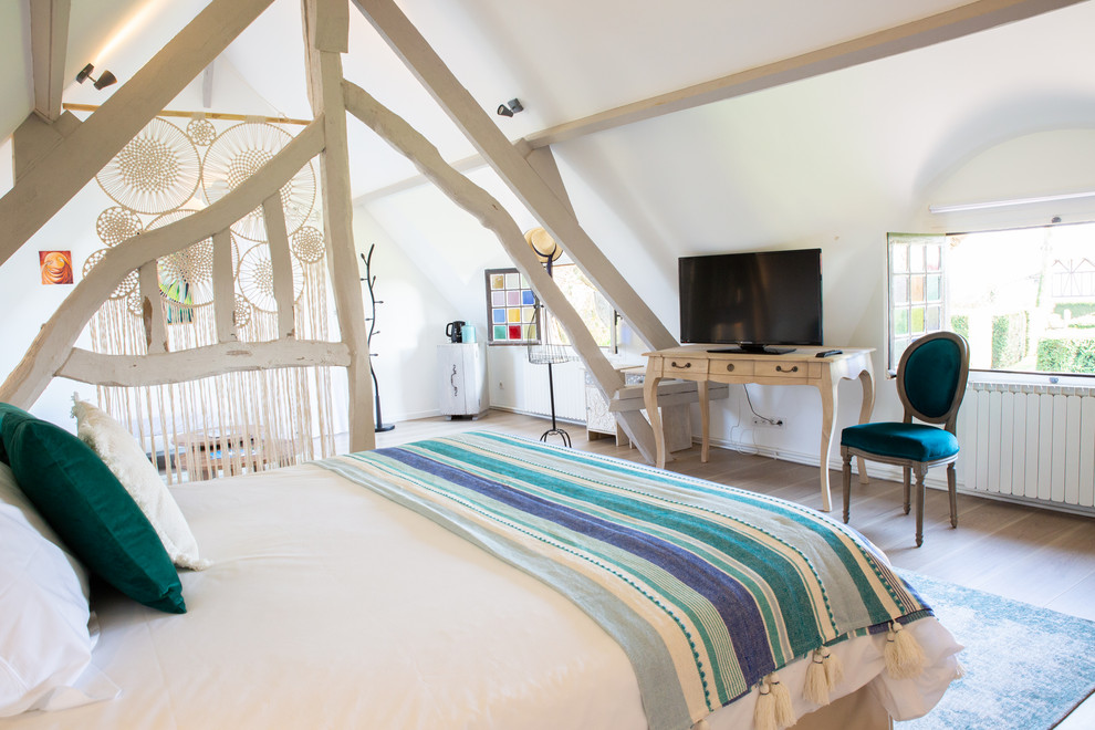 This is an example of a large romantic mezzanine bedroom in Le Havre with white walls, medium hardwood flooring and brown floors.