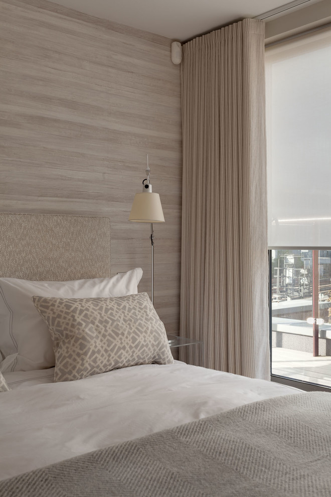 Mid-sized trendy guest light wood floor bedroom photo in London with beige walls