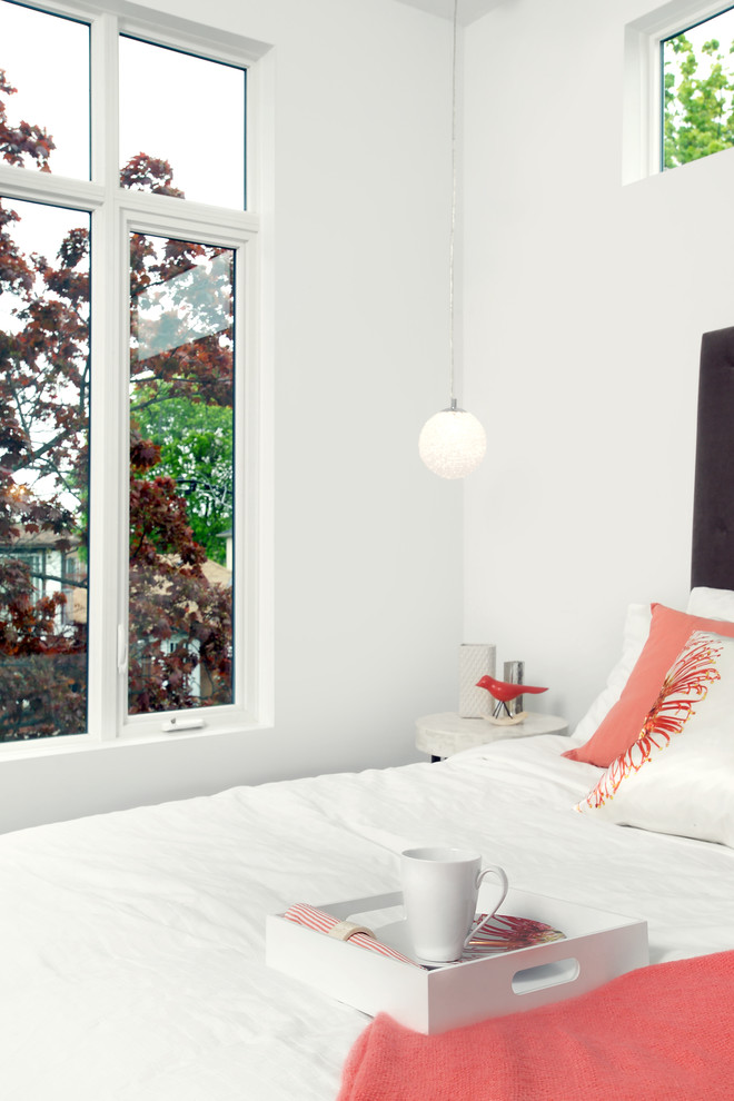 This is an example of a contemporary bedroom in Toronto with white walls.