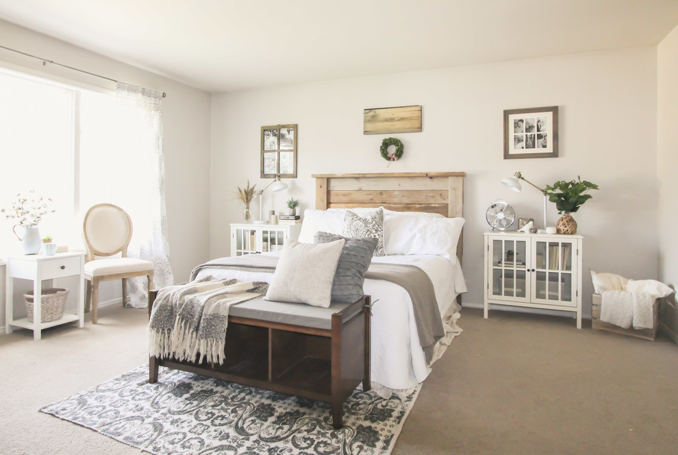 This is an example of a farmhouse bedroom in Seattle with beige walls and carpet.