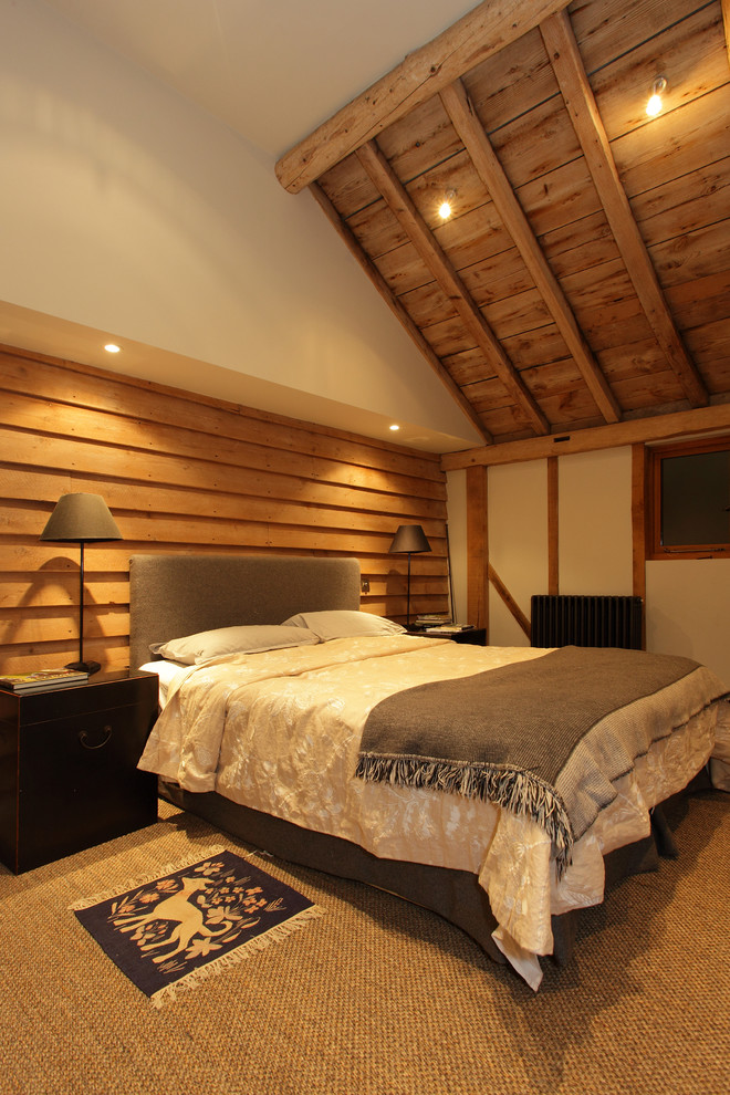 This is an example of a medium sized rustic bedroom in Hampshire with carpet.