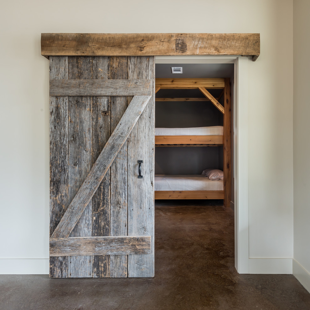 Photo of a medium sized rustic guest bedroom in Atlanta with grey walls and concrete flooring.