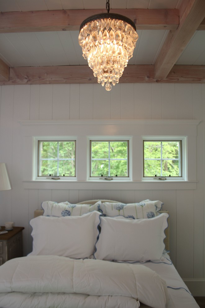 Inspiration for a mid-sized cottage master medium tone wood floor and brown floor bedroom remodel in Boston with white walls