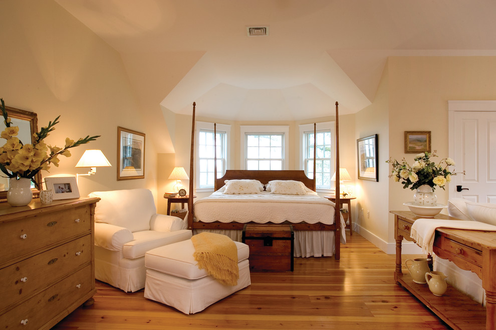Inspiration for a medium sized classic master bedroom in Boston with yellow walls and medium hardwood flooring.