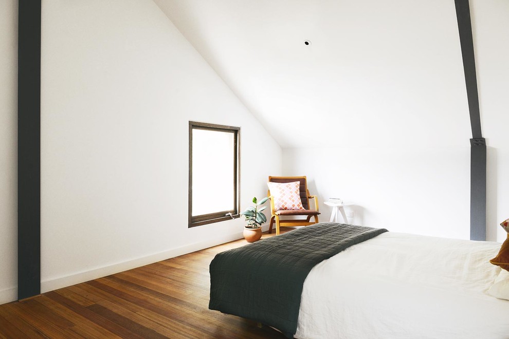 Design ideas for a medium sized urban master bedroom in Melbourne with white walls, medium hardwood flooring and no fireplace.