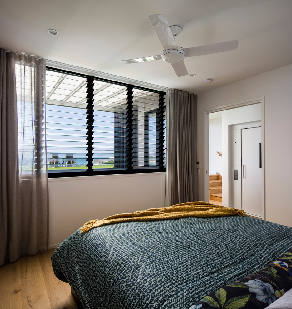 This is an example of a contemporary bedroom in Sunshine Coast.