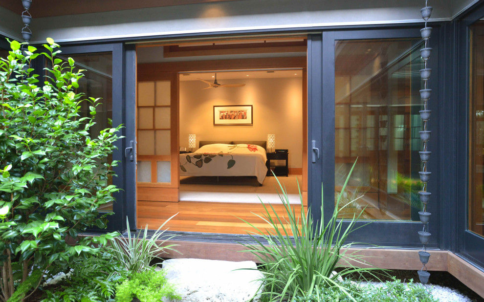 Bedroom - mid-sized zen beige floor and carpeted bedroom idea in Austin with gray walls