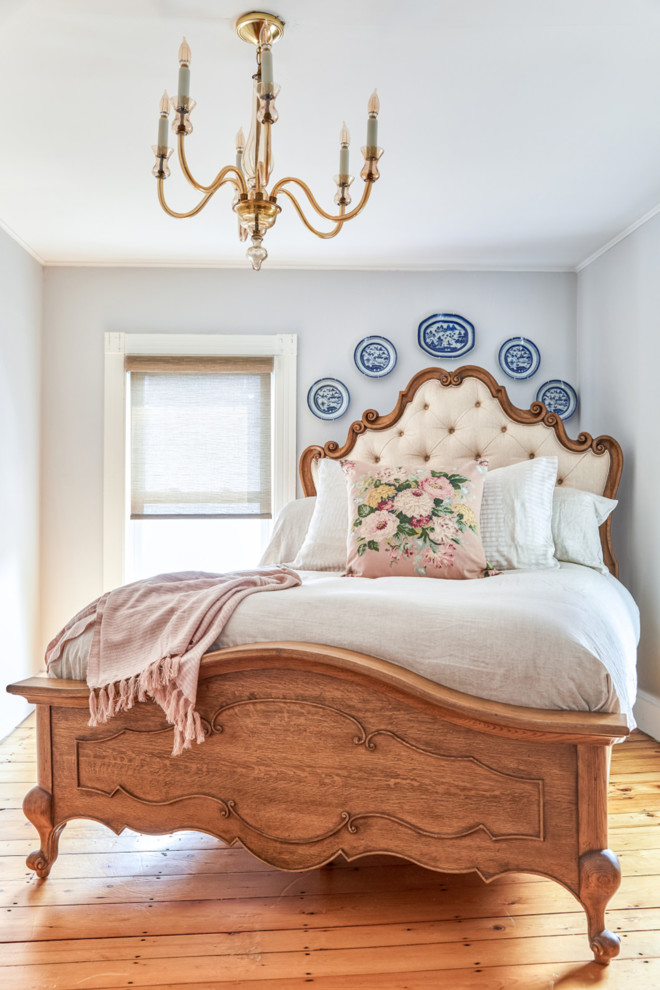 Small ornate master light wood floor bedroom photo in Portland Maine with gray walls